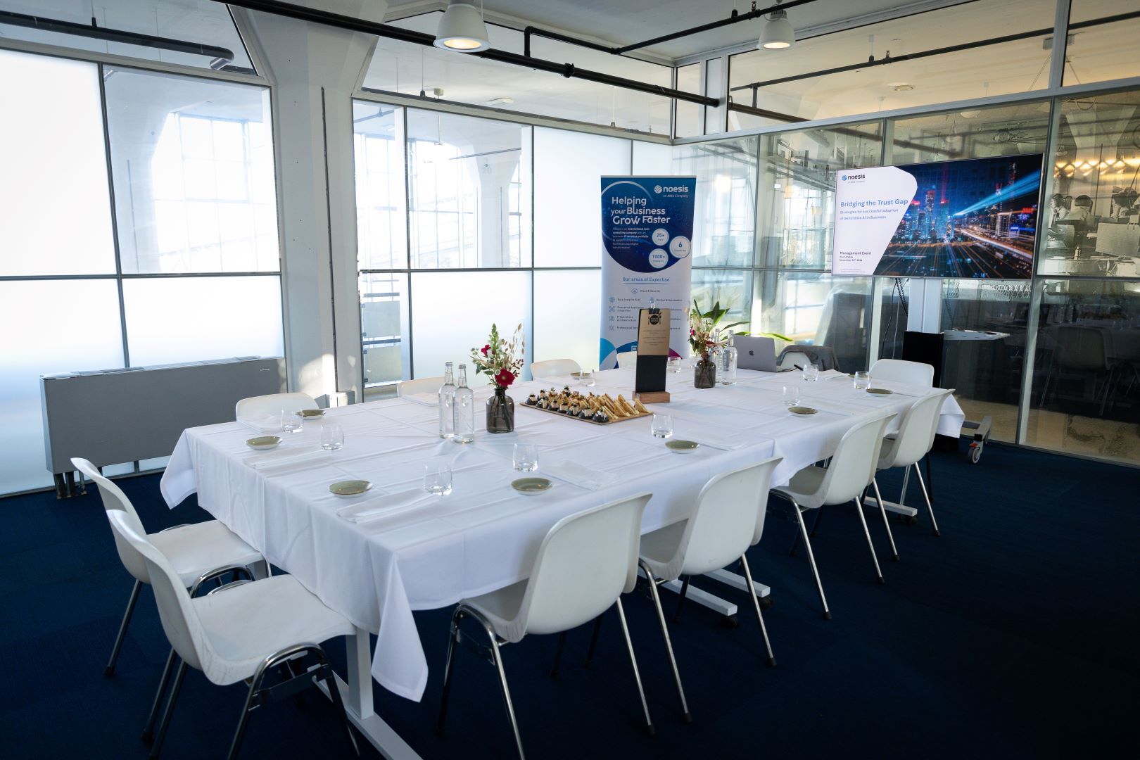 Table set up for discussion with branded presentation materials in background