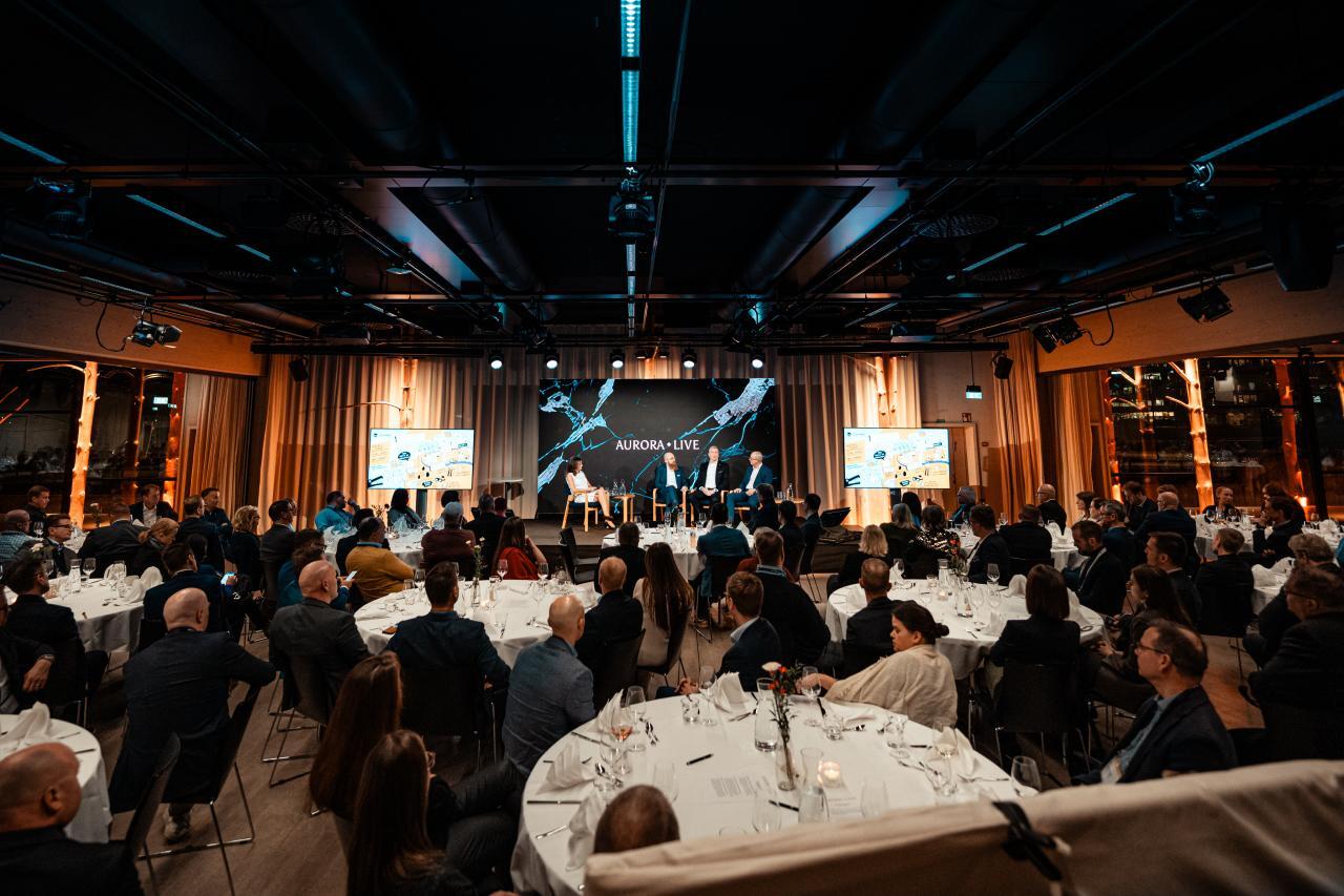 Crowd listening to panel discussion at an executive day event